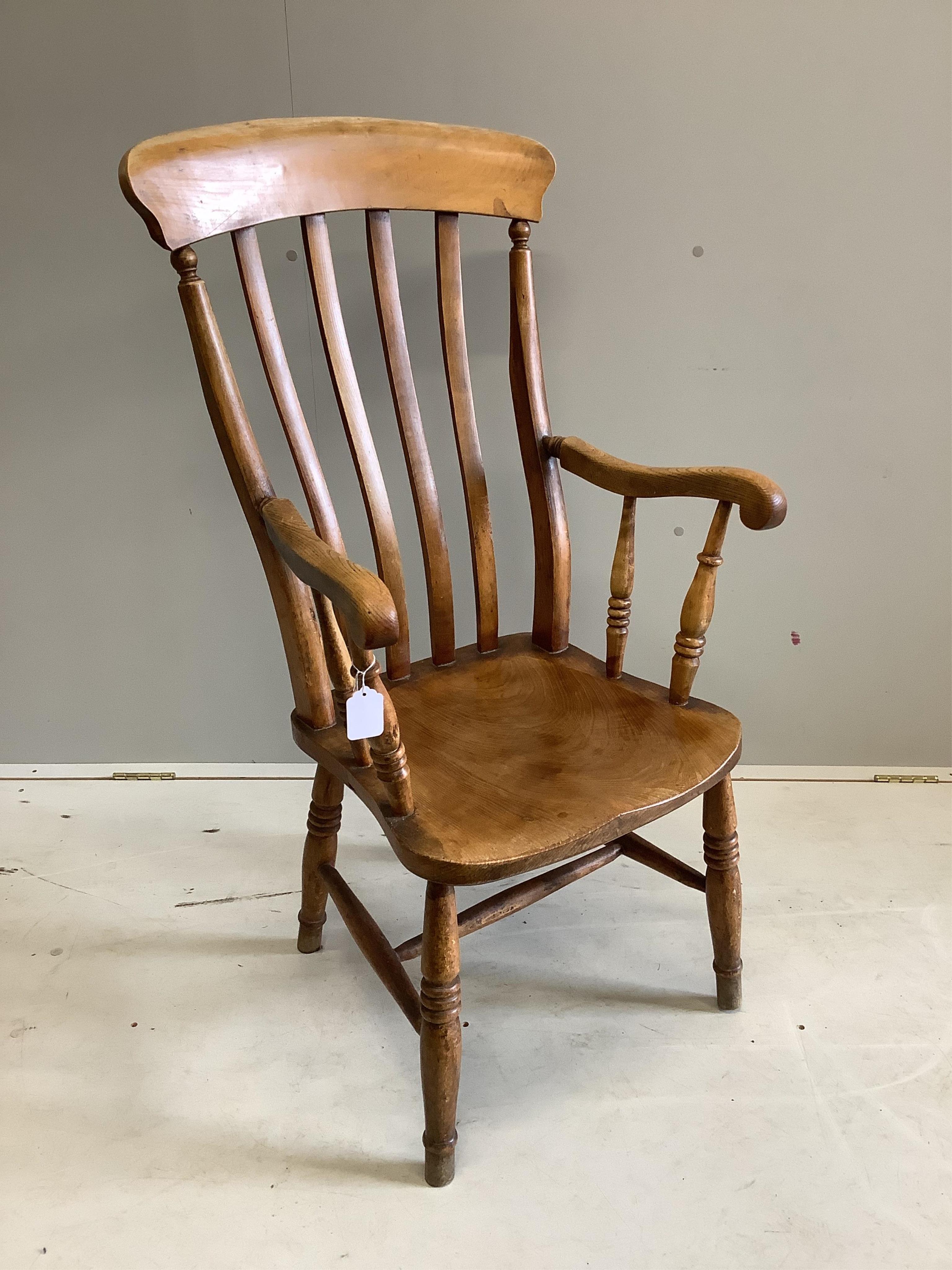 A Victorian elm and beech Windsor lathe back armchair, width 54cm, depth 44cm, height 106cm. Condition - fair